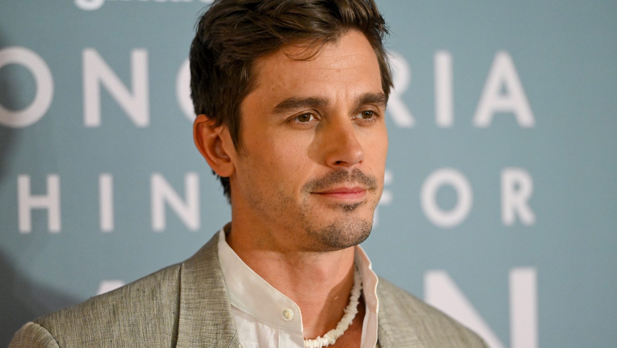 Antoni Porowski revives the nostalgic '90s puka shell necklace trend with a chic modern twist, making waves on the New York City fashion scene.