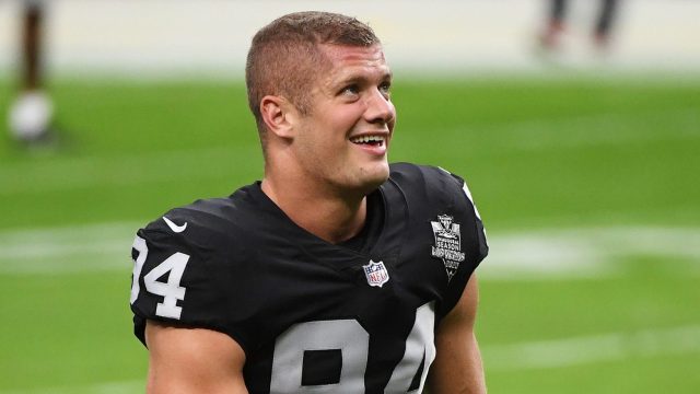 Carl Nassib #94 of the Las Vegas Raiders flexes while smiling during warmups before a game against the Denver Broncos at Allegiant Stadium on November 15, 2020 in Las Vegas, Nevada.