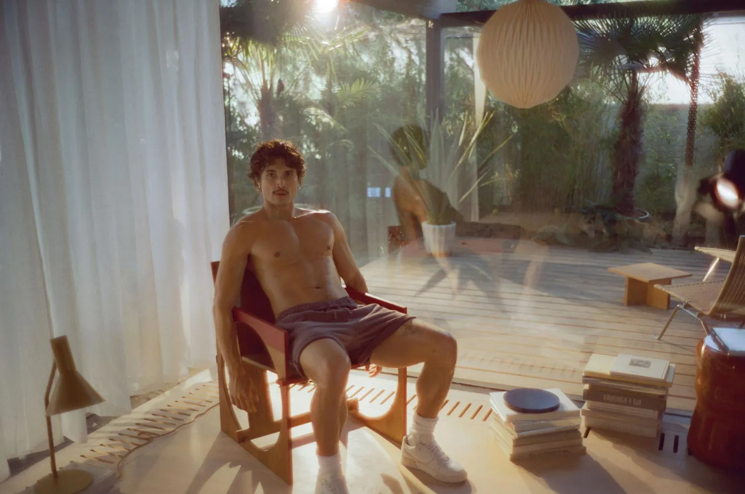 Charles Melton stars in Coach’s latest Soho Sneaker campaign with abs, attitude, and effortless style.