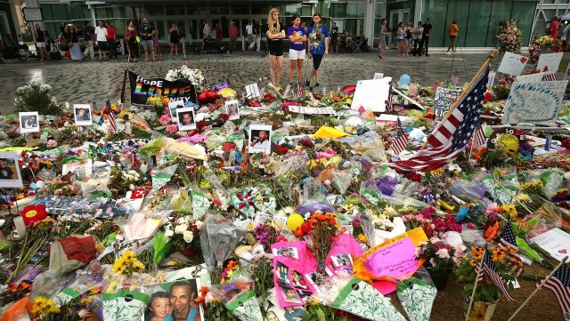 People visit a memorial down the road from the Pulse nightclub on June 19, 2016 in Orlando, Florida. In what is being called the worst mass shooting in American history, Omar Mir Seddique Mateen killed 49 people at the popular gay nightclub early last Sunday. Fifty-three people were wounded in the attack which authorities and community leaders are still trying to come to terms with.