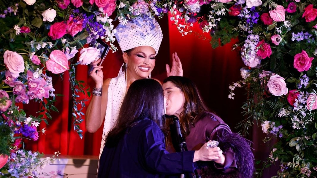 Sasha Colby performs a marriage ceremony for Hannah Nececkas and Amanda Seda as Them and Destination DC kick off World Pride 2025 at Succotash on May 30, 2025 in Washington, DC. Photo: Paul Morigi/Getty Images for Them