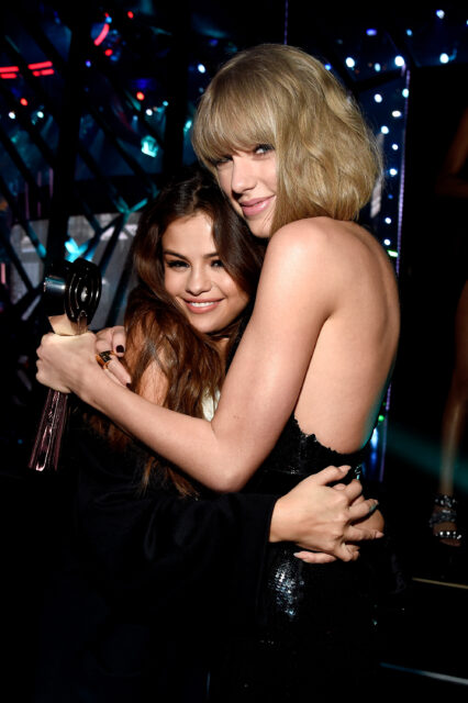 Singer Taylor Swift (R), winner of the Album of the Year award for '1989,' embraces actress/singer Selena Gomez backstage at the iHeartRadio Music Awards which broadcasted live on TBS, TNT, AND TRUTV from The Forum on April 3, 2016 in Inglewood, California.