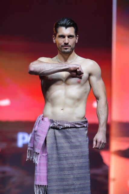 The men of Mister Global 2025 walk the stage in traditional Thai attire.