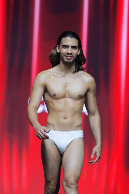 The men of Mister Global 2025 walk the stage for the swimsuit category in Thailand.