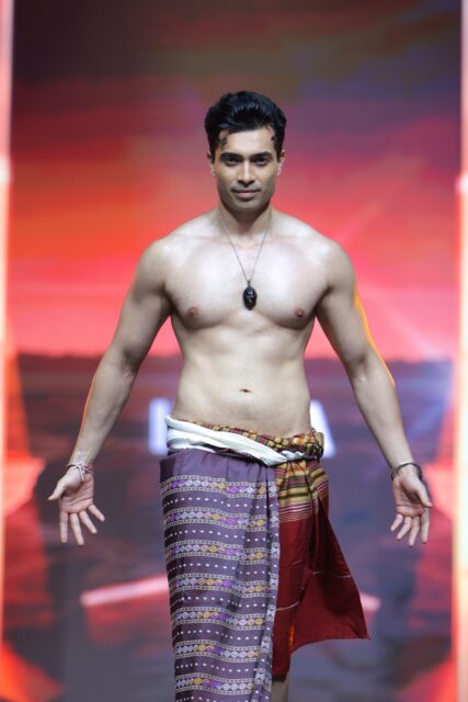 The men of Mister Global 2025 walk the stage in traditional Thai attire.