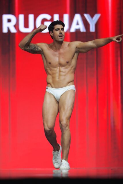 The men of Mister Global 2025 walk the stage for the swimsuit category in Thailand.