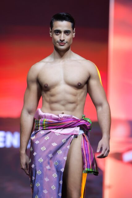 The men of Mister Global 2025 walk the stage in traditional Thai attire.