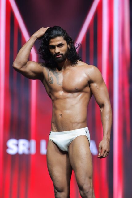 The men of Mister Global 2025 walk the stage for the swimsuit category in Thailand.
