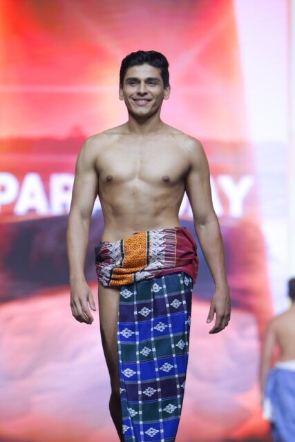The men of Mister Global 2025 walk the stage in traditional Thai attire.