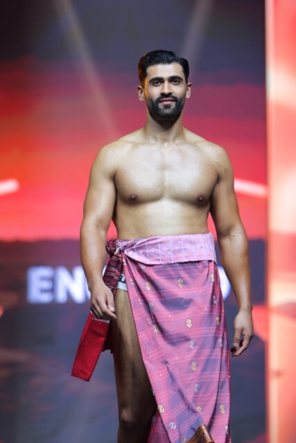 The men of Mister Global 2025 walk the stage in traditional Thai attire.