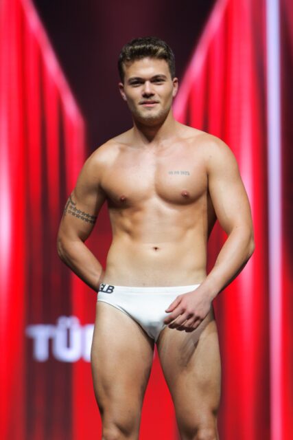 The men of Mister Global 2025 walk the stage for the swimsuit category in Thailand.