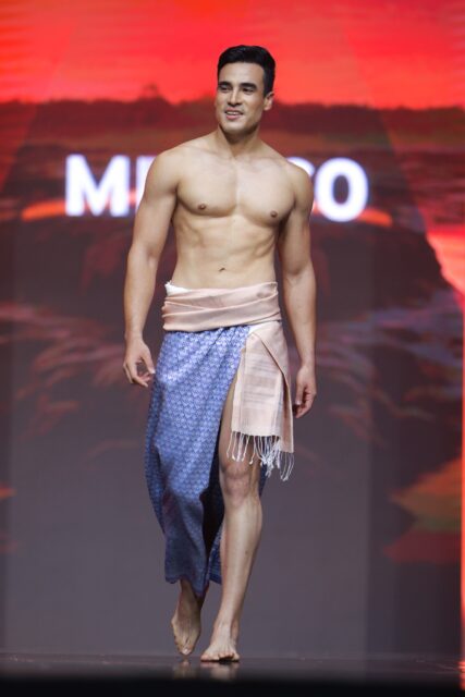 The men of Mister Global 2025 walk the stage in traditional Thai attire.
