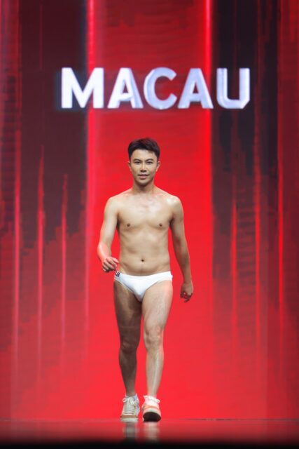 The men of Mister Global 2025 walk the stage for the swimsuit category in Thailand.