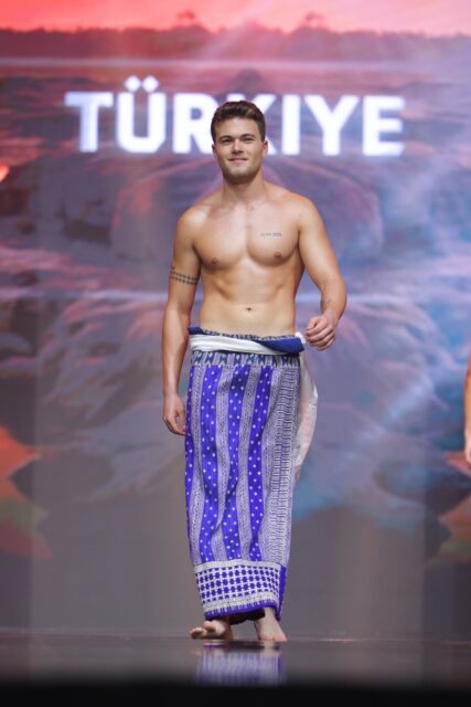 The men of Mister Global 2025 walk the stage in traditional Thai attire.