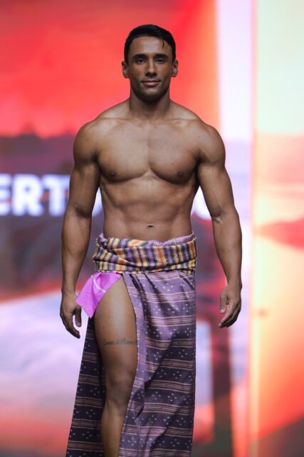 The men of Mister Global 2025 walk the stage in traditional Thai attire.