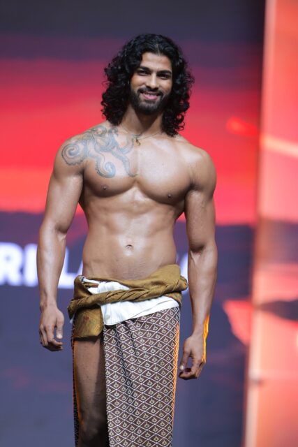 The men of Mister Global 2025 walk the stage in traditional Thai attire.