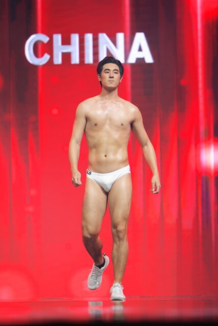 The men of Mister Global 2025 walk the stage for the swimsuit category in Thailand.