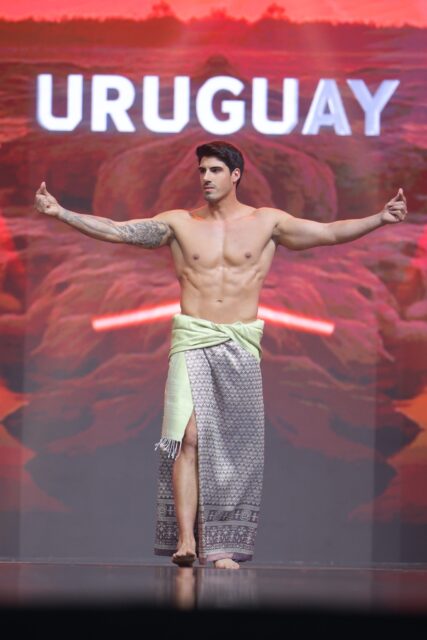 The men of Mister Global 2025 walk the stage in traditional Thai attire.