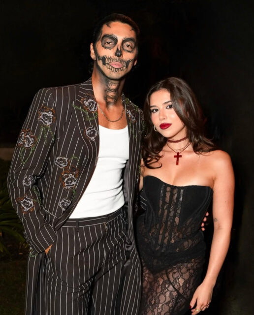 Michael Cimino and Taylor Zakhar Perez turn heads in skeleton makeup at Carlos Eric Lopez’s Día de Muertos Gala, blending glamour and spooky style.