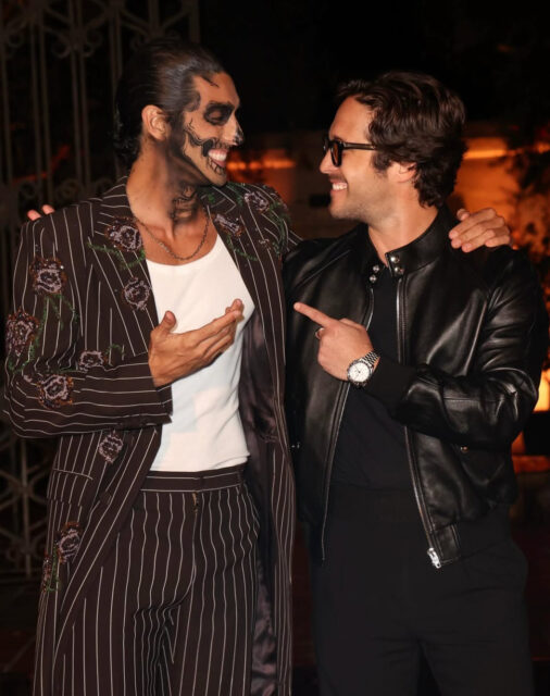 Michael Cimino and Taylor Zakhar Perez turn heads in skeleton makeup at Carlos Eric Lopez’s Día de Muertos Gala, blending glamour and spooky style.