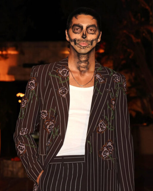 Michael Cimino and Taylor Zakhar Perez turn heads in skeleton makeup at Carlos Eric Lopez’s Día de Muertos Gala, blending glamour and spooky style.