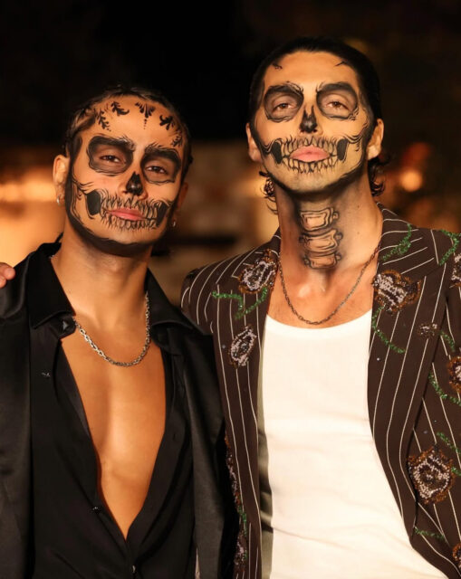 Michael Cimino and Taylor Zakhar Perez turn heads in skeleton makeup at Carlos Eric Lopez’s Día de Muertos Gala, blending glamour and spooky style.