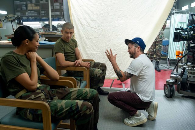 BOOTS. (L to R) Troy Leigh-Anne Johnson as Alice, Liam Oh as Ray McAffey, and Director Silas Howard (104, 105) behind the scenes of Episode 104 of Boots. Cr. Patti Perret/Netflix © 2024