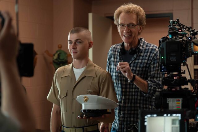 BOOTS. (L to R) Miles Heizer as Cameron Cope and Director Phil Abraham behind the scenes of Episode 108 of Boots. Cr. Alfonso "Pompo" Bresciani/Netflix © 2023