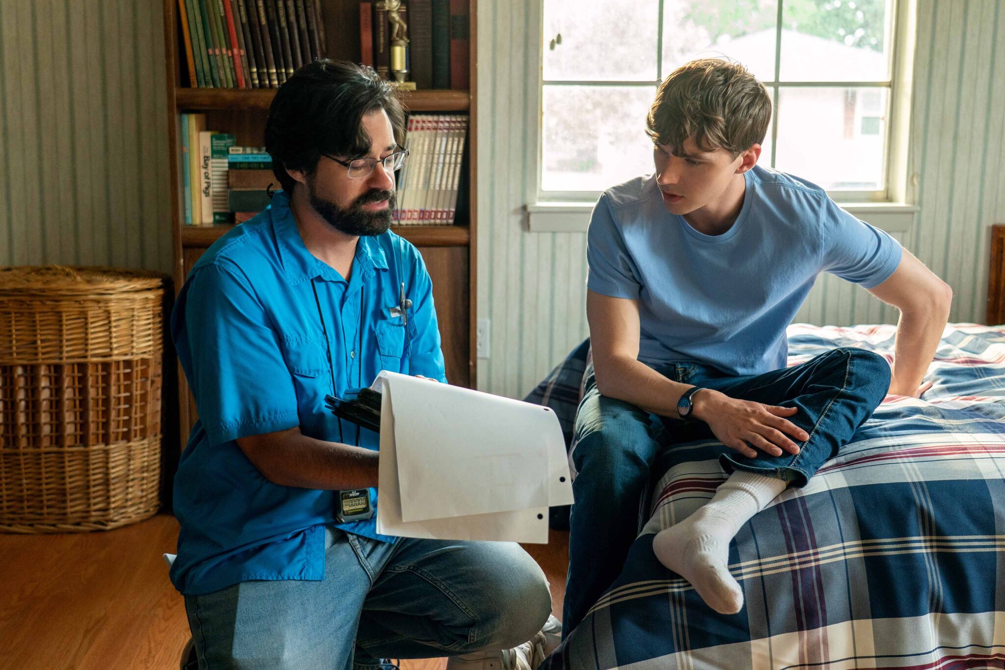 BOOTS. (L to R) Script Supervisor Nick DiRosa and Miles Heizer as Cameron Cope behind the scenes of Episode 101 of Boots. Cr. Alfonso "Pompo" Bresciani/Netflix © 2023