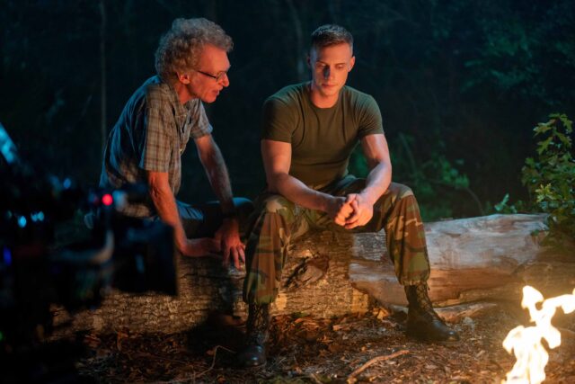BOOTS. (L to R) Director Peter Hoar (101) and Max Parker as Sgt. Sullivan behind the scenes of Episode 103 of Boots. Cr. Alfonso "Pompo" Bresciani/Netflix © 2023