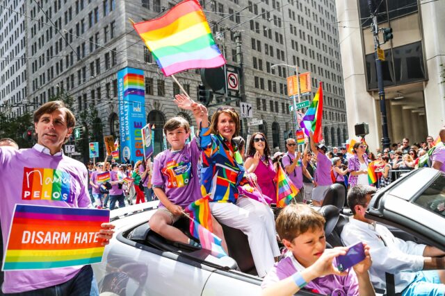 Nancy Pelosi waves a flag from a car during the 46th annual LGBT Pride Parade, in San Francisco, California, on Sunday, June 26, 2016.
