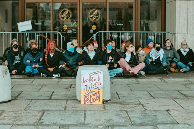 Twenty-four people were arrested after activists blockaded HHS over proposed rules that could cut off gender-affirming care for trans youth nationwide.