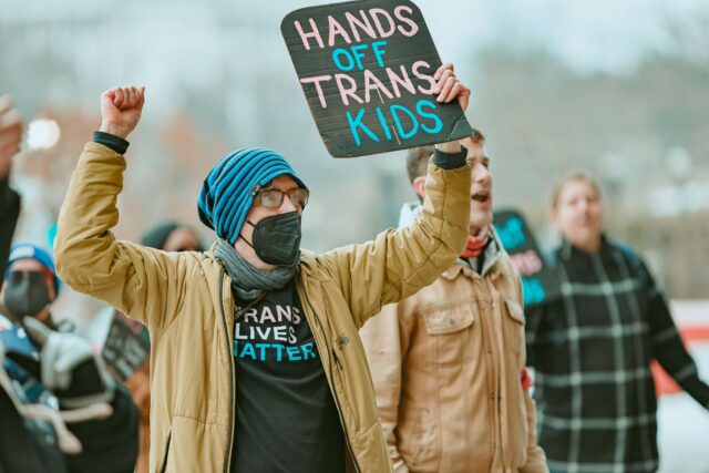 Twenty-four people were arrested after activists blockaded HHS over proposed rules that could cut off gender-affirming care for trans youth nationwide.