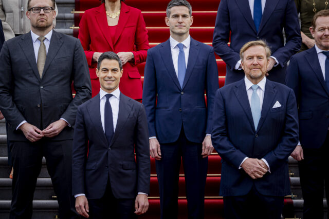 King Willem-Alexander of The Netherlands (R) poses for an official picture with new Dutch Prime Minister Rob Jetten (L) and his cabinet at Huis ten Bosch Palace on February 23, 2026 in The Hague, Netherlands.  