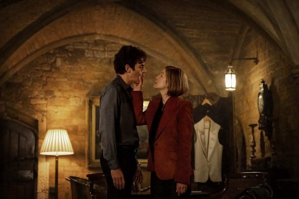 Ladies First. (L-R) Sacha Baron Cohen as Damien Sachs and Rosamund Pike as Alex Fox in Ladies First. Cr. Rob Youngson/Netflix © 2026.