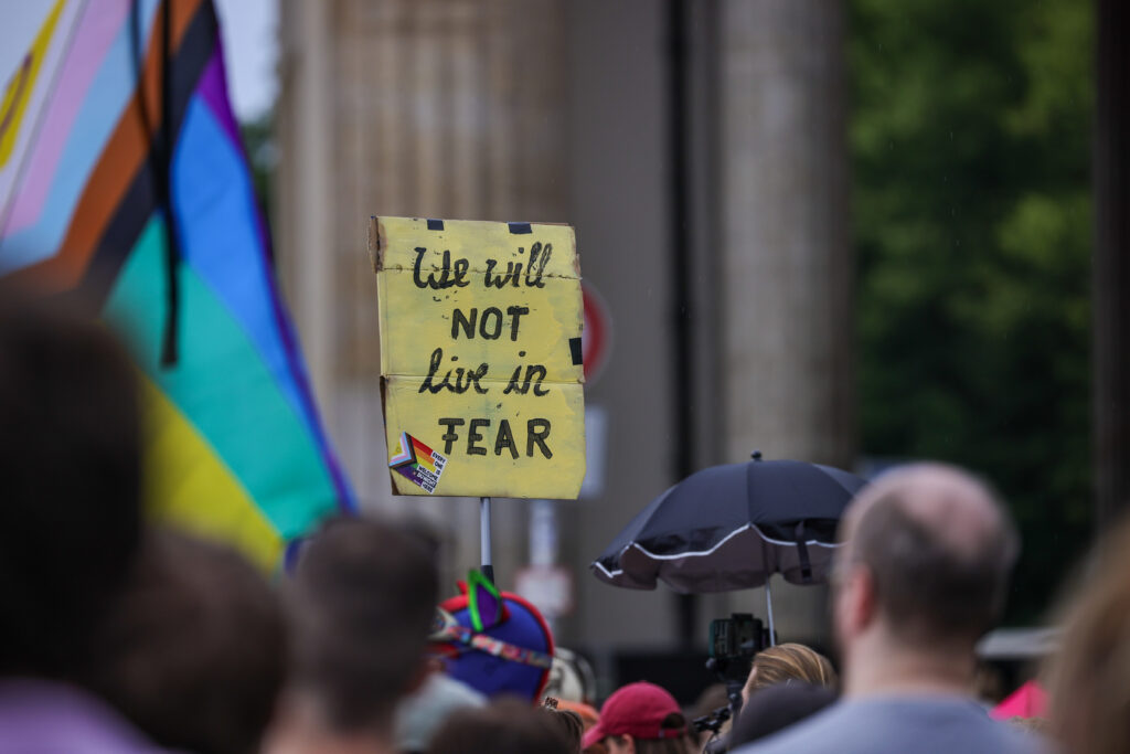 People gather at Pariser Platz in front of the Brandenburg Gate in a memorial demonstration following the alleged attack carried out last night at Tiergarten park, in which a van plowed through a crowd of revelers attending Christopher Street Day Berlin pride parade, on July 26, 2026 in Berlin, Germany. At approximately 10:00pm last night Abdul B. drove the van into a crowd in Tiergarten park, killing one woman and injuring 16. Three victims are reportedly in critical condition. (Photo by Omer Messinger/Getty Images)