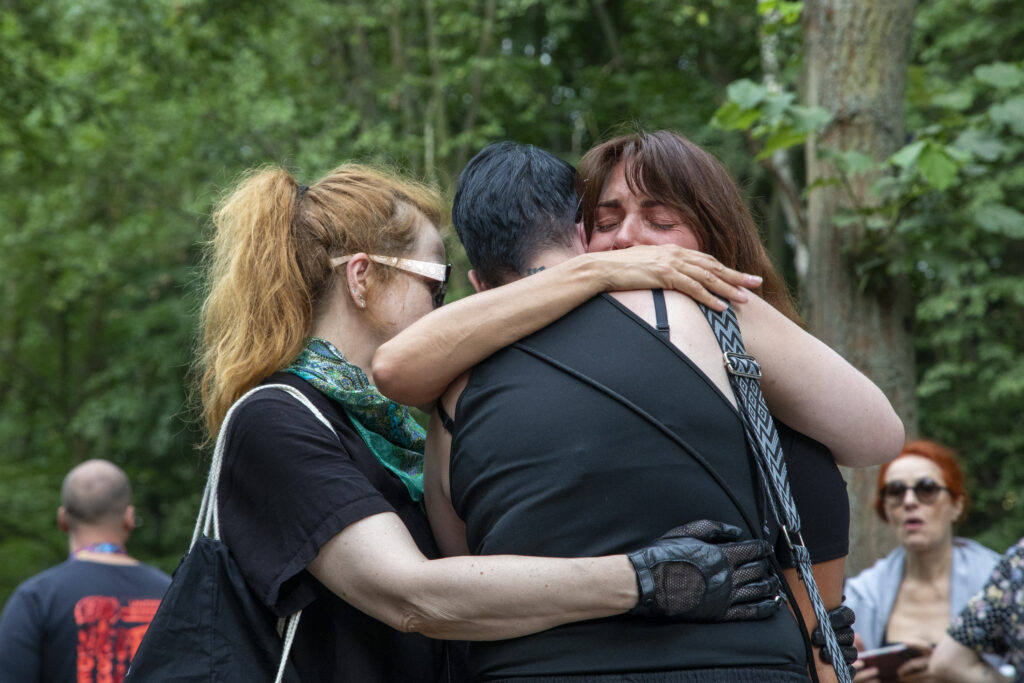 People embrace each other as they mourn near the site where suspect Abdul B. allegedly carried out last night's attack with a white van against revelers at the Christopher Street Day Berlin Pride parade, on July 26, 2026, in Berlin, Germany. At approximately 10:00pm last night Abdul B. drove the van into a crowd in Tiergarten park, killing one woman and injuring 16. Three victims are reportedly in critical condition. (Photo by Massimo Di Nonno/Getty Images)