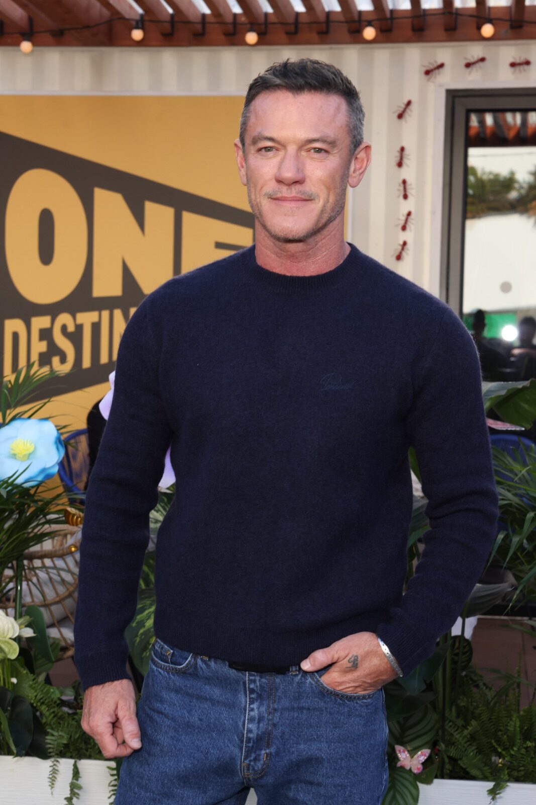 Luke Evans wearing a navy sweater and jeans at the ITV photocall in Cannes.